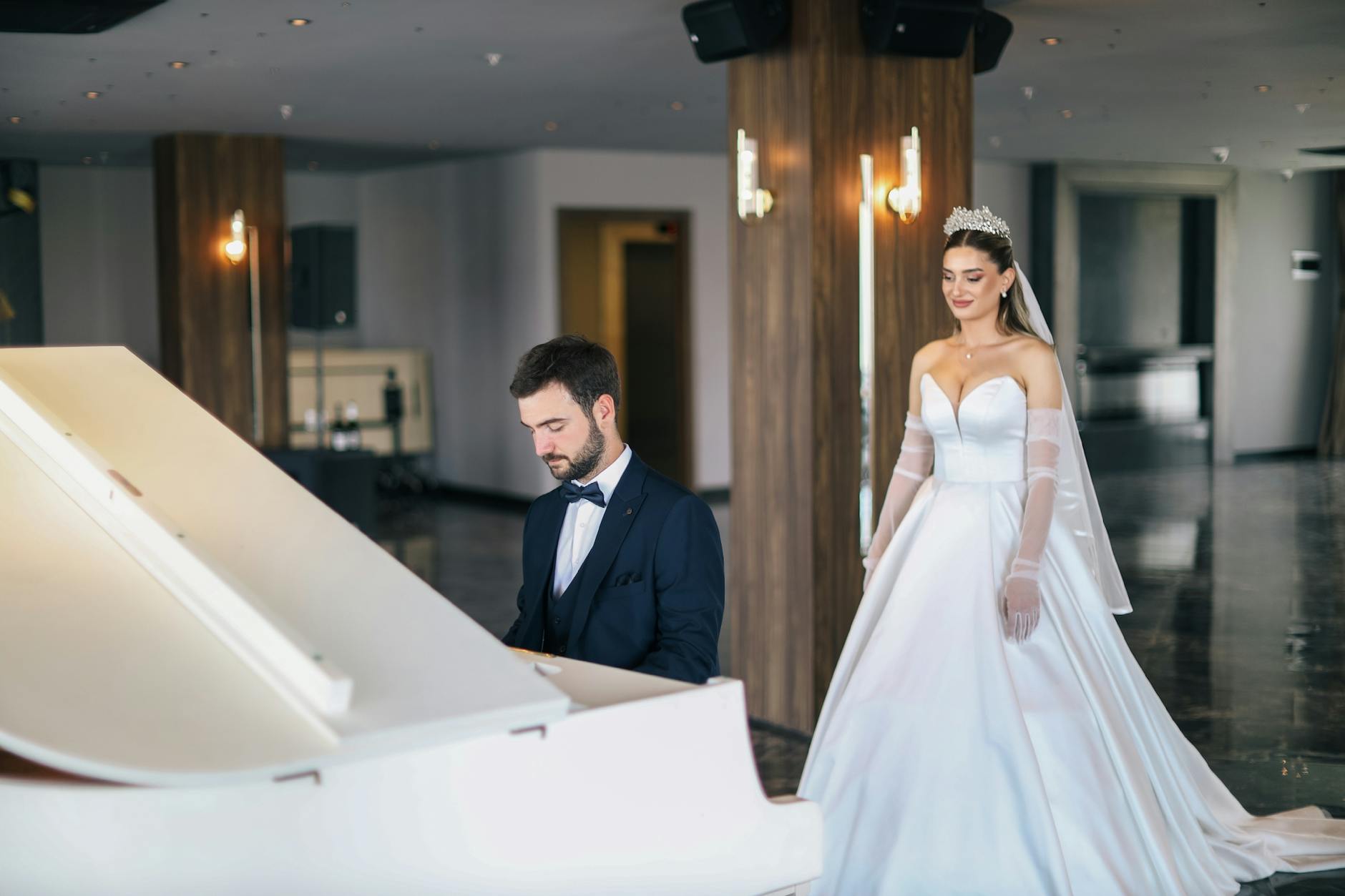 Para młoda w eleganckich strojach w sali ślubnej